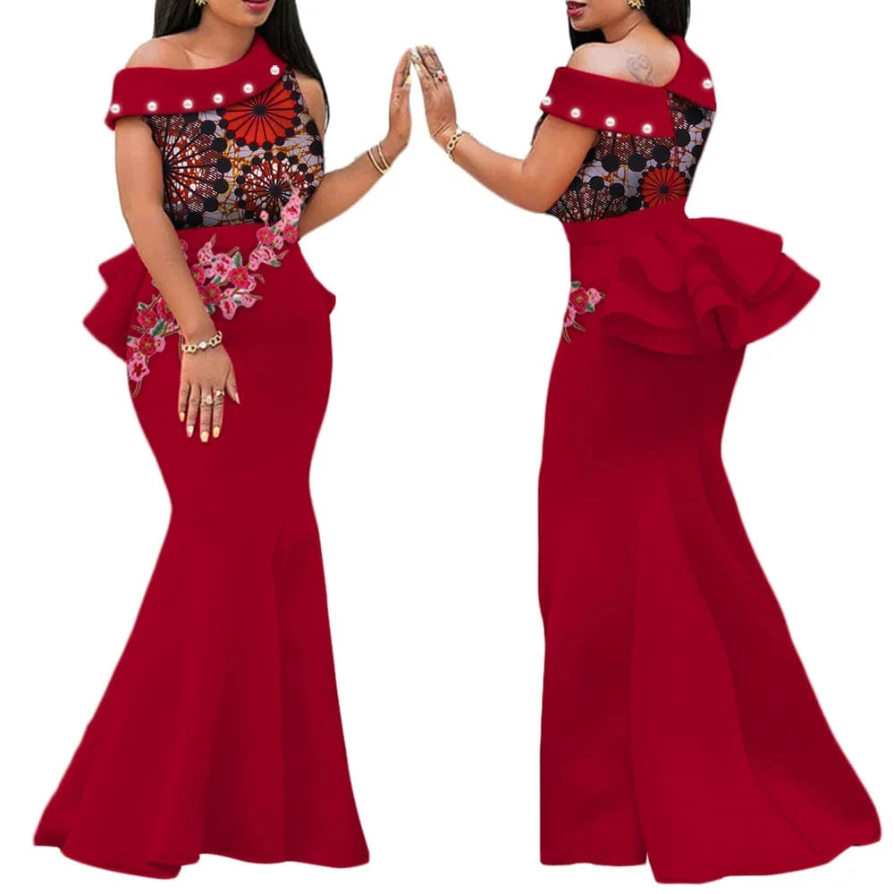 African print long dress with cotton applique and draped design, featuring beaded embellishments, worn by a woman at a party.
