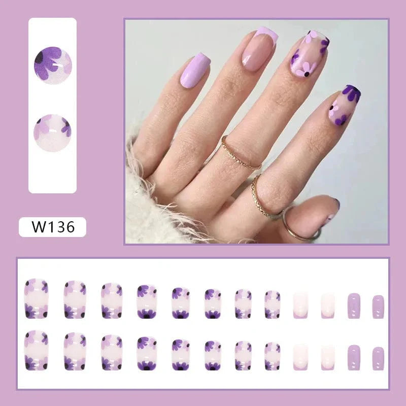 Purple floral almond press-on nails by Showlu Fashion Store, 24-piece set with detachable acrylic tips and floral design for manicures.