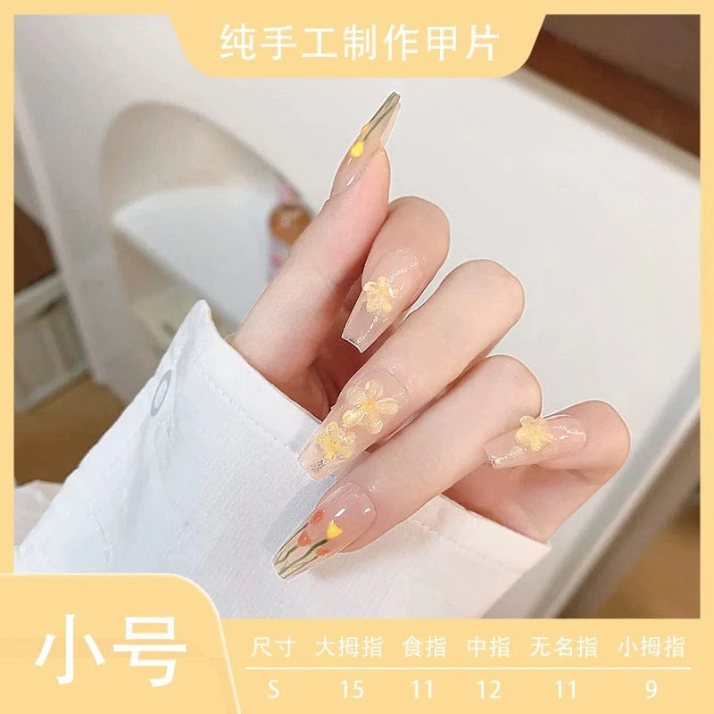 Showlu Fashion Store Xiaonan Classmate Aurora Camellia press-on nails with a gentle blush design and elegant, long nail style.