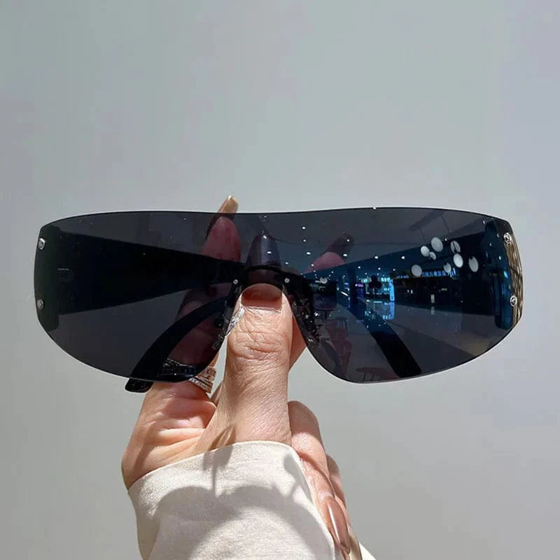 Buyuteen Y2K rimless sunglasses by Showlu Fashion with pink steampunk UV400 lenses, stylish one-piece design for women and men.