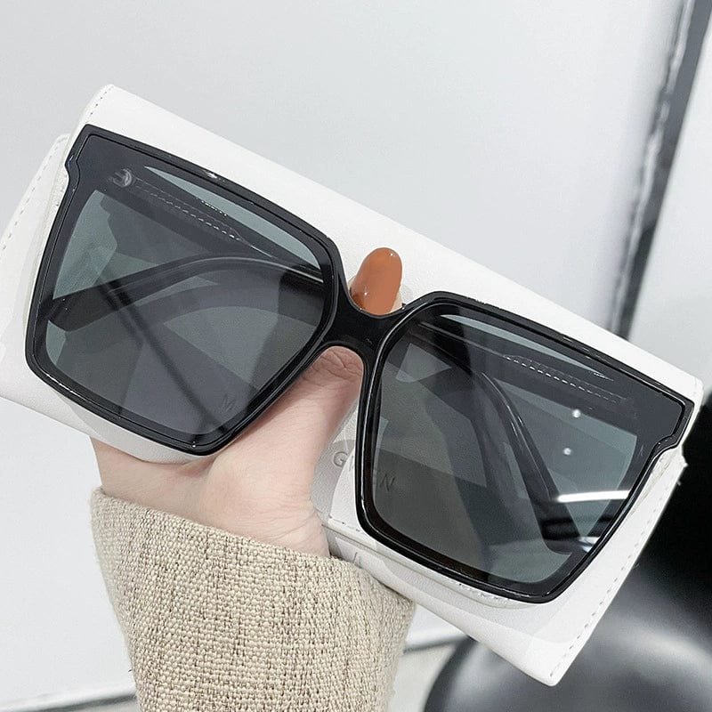 Showlu Fashion women's oversized sunglasses with black frames and dark green lenses, offering UV protection and trendy summer style.