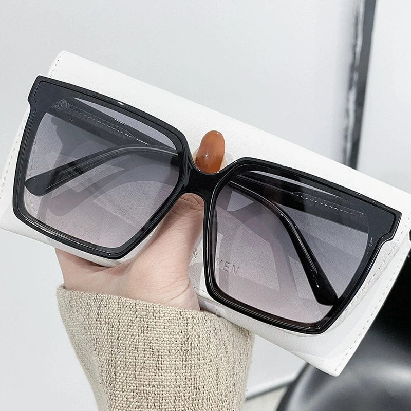 Showlu Fashion women's oversized black frame sunglasses with gray lenses, stylish UV protection and trendy summer sun protection.