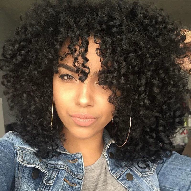 A woman wearing a short, voluminous black wig with tight, defined curls and bangs.