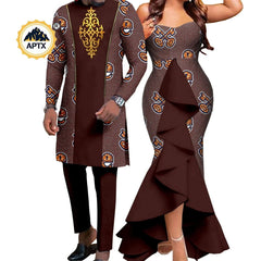 A man and woman wearing matching brown African print outfits with gold patterns and ruffles.