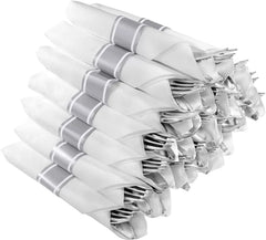 A stack of twenty-five silver plastic cutlery sets wrapped in white napkins with silver bands.
