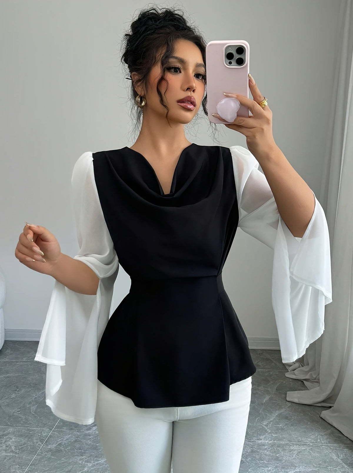 SHOWLU Women's black and white pleated asymmetrical long sleeve blouse with a stylish, flowing design and unique hem detail.