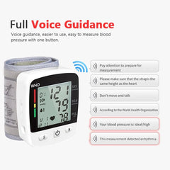A white digital wrist blood pressure monitor with an LCD screen and voice guidance features.