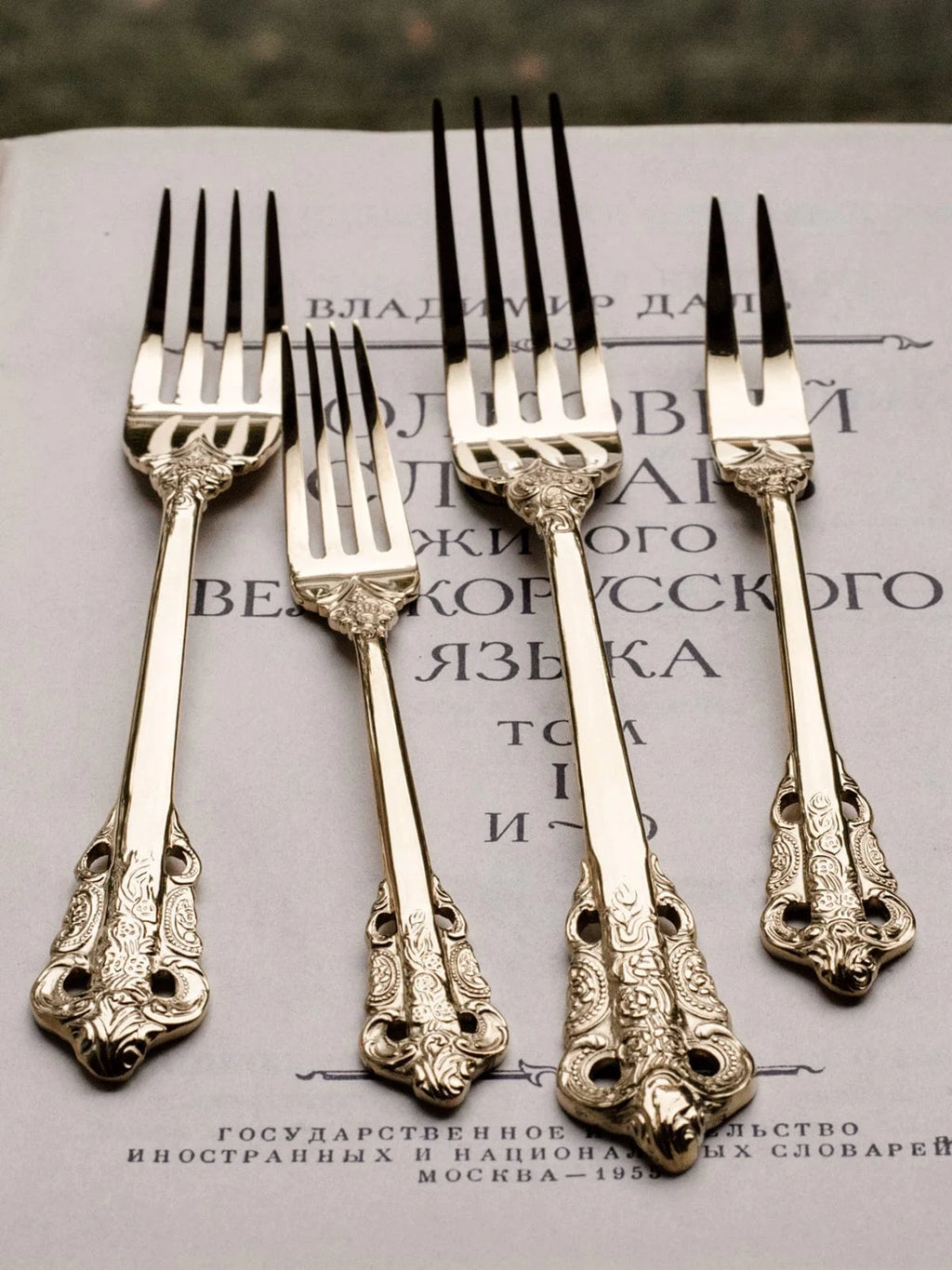 Showlu French retro relief stainless steel main meal and dessert spoon and fork set on a white background.