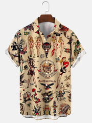 A short-sleeved button-down shirt featuring a tan background with vintage tattoo-style graphics.