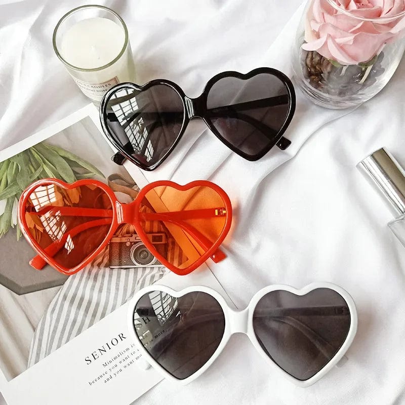 Winful women's retro heart-shaped sunglasses with UV400 mirror lenses, candy colors, and decorative red accents for stylish sun protection.