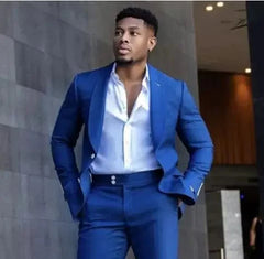 A man wears a slim-fit royal blue suit with a white button-down shirt.