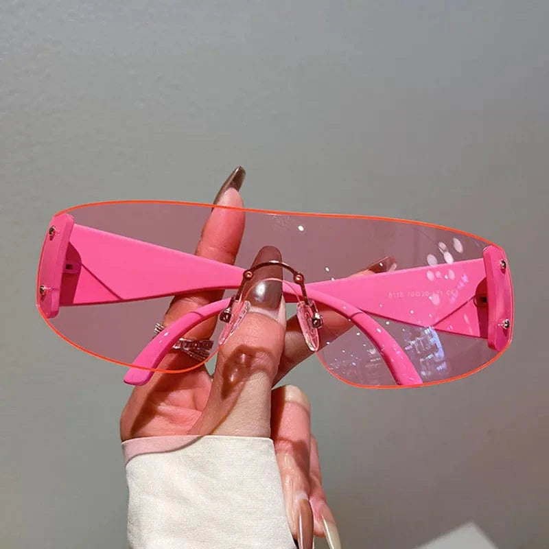 Buyuteen Y2K rimless pink sunglasses by Showlu Fashion, luxury steampunk UV400 shades for women and men with rivet details.