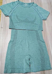 A sage green seamless fitness set featuring a short-sleeve crop top and high-waisted shorts.