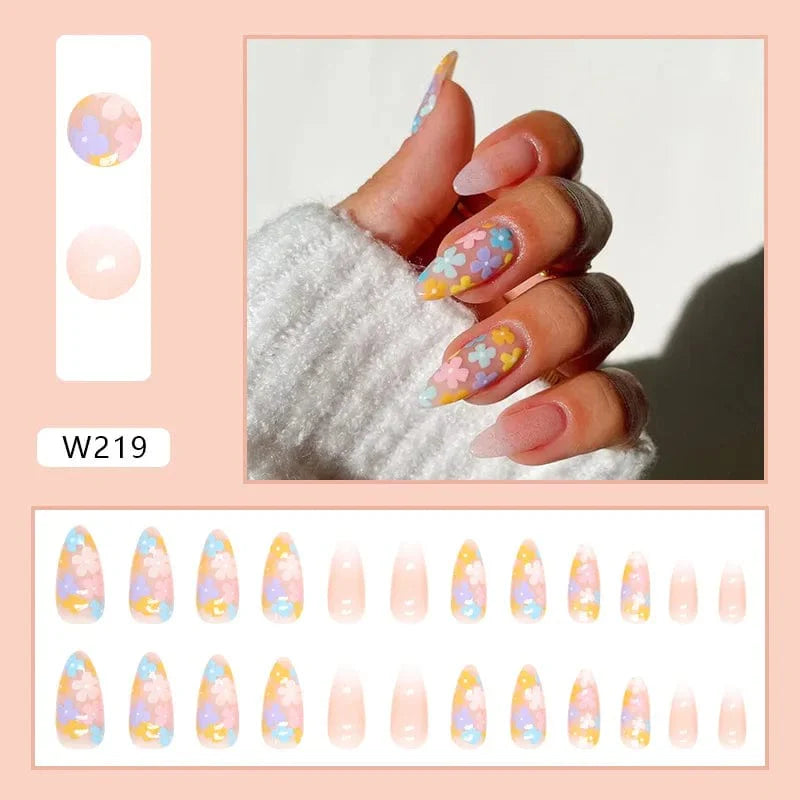 Showlu Purple Floral Almond Press-On Nails in 24-piece box, featuring floral design, detachable acrylic tips, and ballerina nail shape.