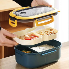 A blue and yellow two-layer rectangular lunch box with a removable food tray and utensils.