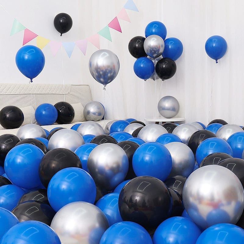 Six blue and white macaron-shaped balloons in a birthday or graduation decoration setup, featuring dark and light blue hues.