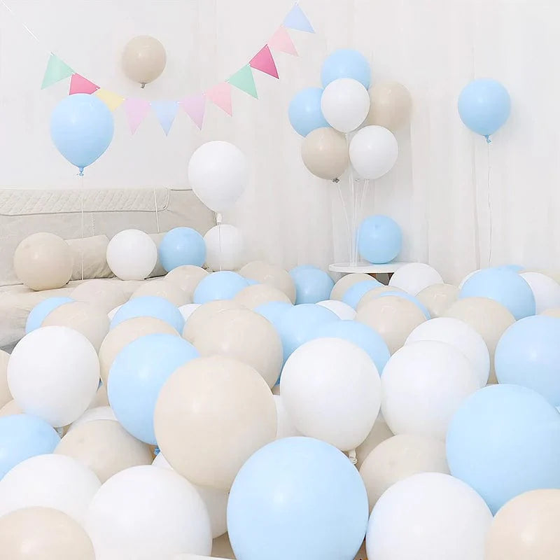 Six blue and white macaron-shaped balloons in a birthday or graduation decoration setup, featuring dark and light blue tones.