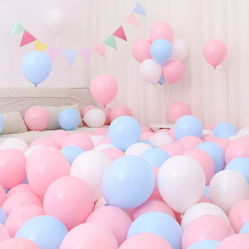 Six blue and white macaron-shaped balloons in a birthday and graduation decoration scene with blue balloons and festive setup.