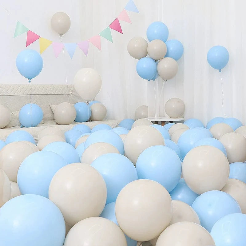 Six blue and white macaron-shaped balloons in a birthday and graduation decoration scene with blue and white balloons.