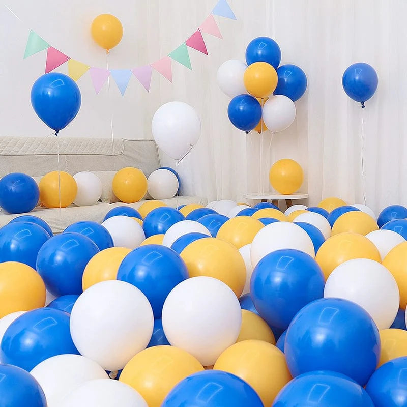 Six blue and white macarons with blue balloons for birthday or graduation decoration scene layout.