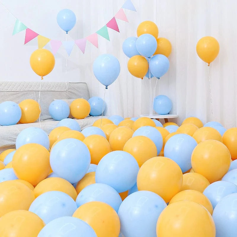Six blue and white macaron-shaped balloons in a birthday and graduation decoration setup, featuring dark and light blue balloons.