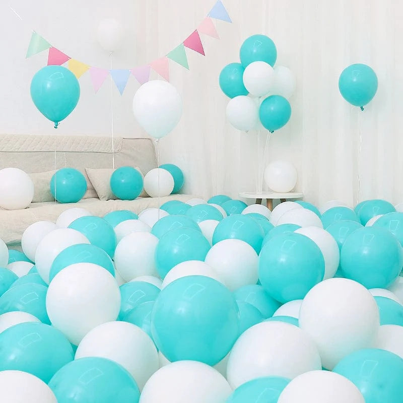 Six blue and white macaron-shaped balloons in a birthday and graduation decoration setup with blue and white theme.