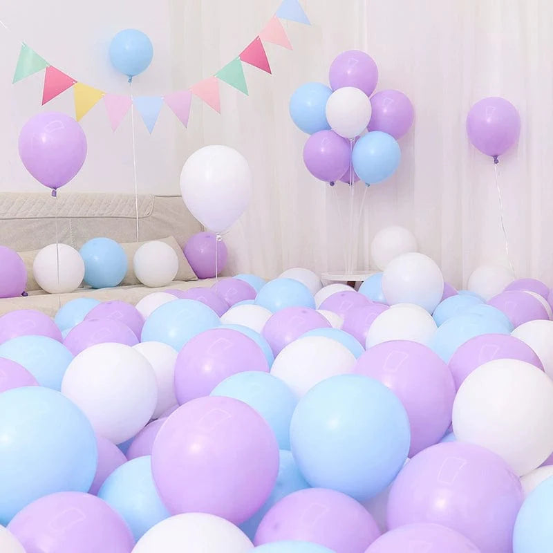 Six blue and white macaron-shaped balloons in a birthday or graduation decoration scene, featuring blue and light blue balloons.