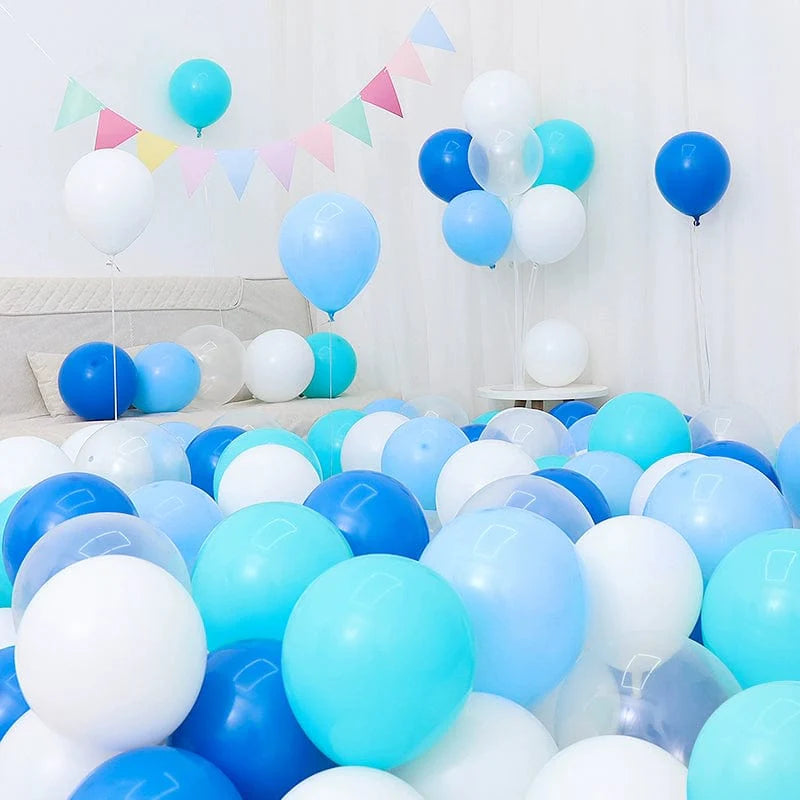 Six blue and white macaron-shaped balloons in a birthday or celebration decoration setup, featuring dark and light blue shades.