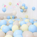 Six blue and white macaron-shaped balloons, ideal for birthday or graduation decorations, in a festive scene.