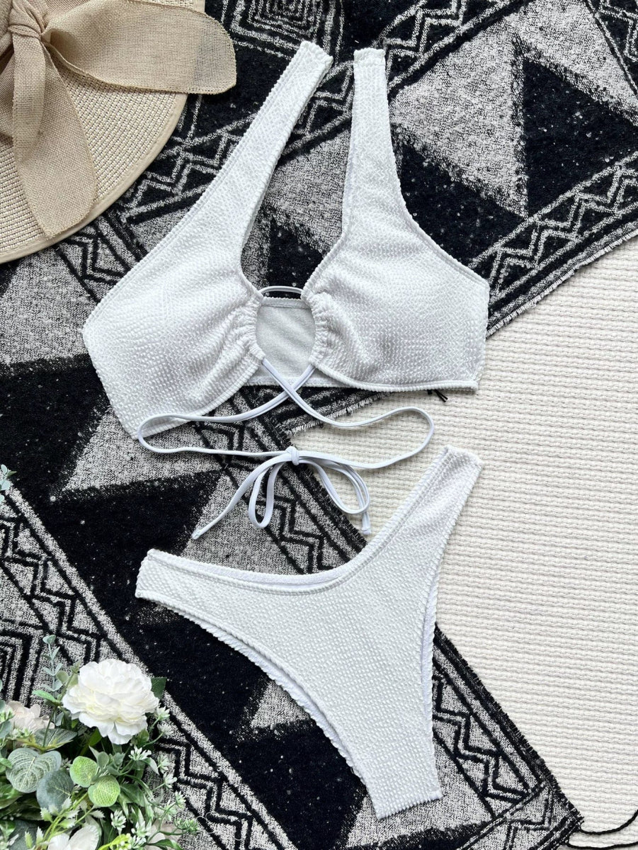 Showlu Plus Size Hollow-Out Triangle Bikini in solid color with high-waist design, featuring stylish cut-out details for a fashionable swim look.