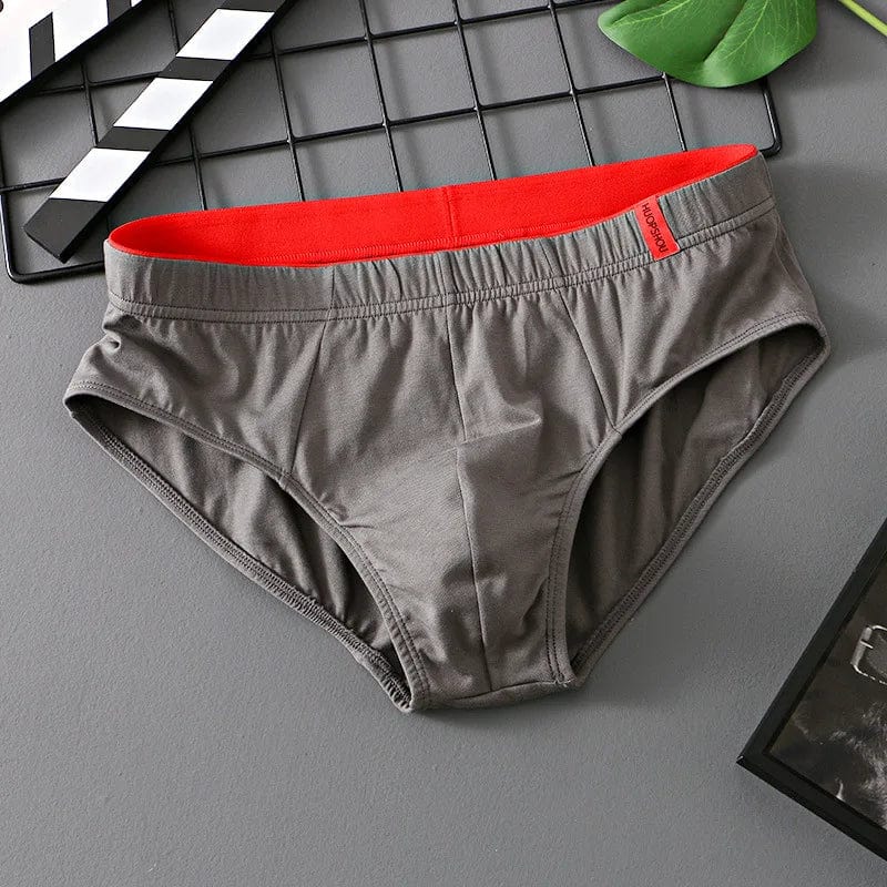 Showlu men's cotton convex pouch briefs in solid color, low-rise breathable underwear with comfortable fit.