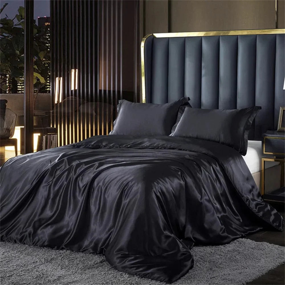 Luxury silk satin bedding set with duvet cover, pillowcases, and bed sheet in elegant solid design for king, queen, or twin beds.