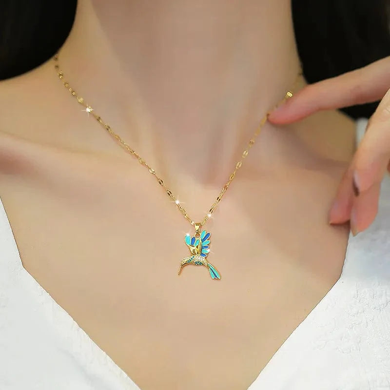 Blue stainless steel hummingbird pendant necklace for women, featuring a delicate bird design on a chain, stylish animal jewelry.