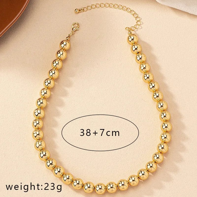Gold ball beads chain necklace featuring steampunk gothic style, worn as a choker for men and women, stylish jewelry accessory