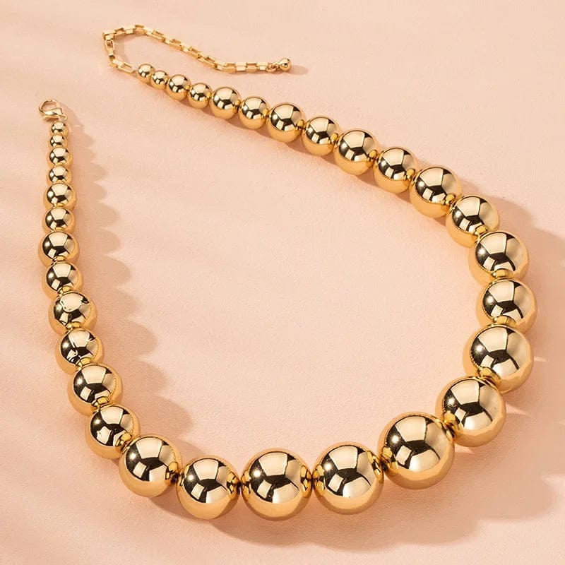 Gold ball beads chain necklace featuring steampunk Gothic style, worn as a choker for women and men, trendy fashion jewelry.