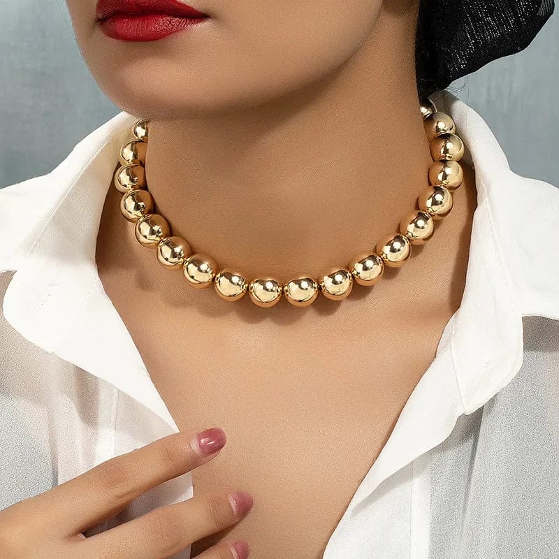 Gold ball beads chain necklace featuring steampunk gothic style, worn as a choker jewelry piece for women and men.