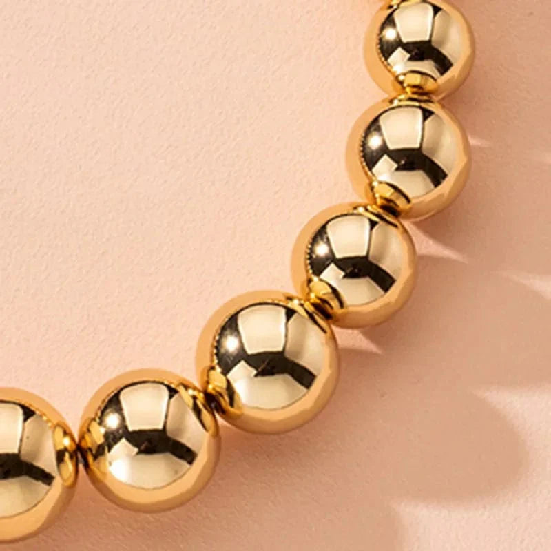 Gold ball beads chain necklace featuring a steampunk gothic design, perfect as a choker for women and men.