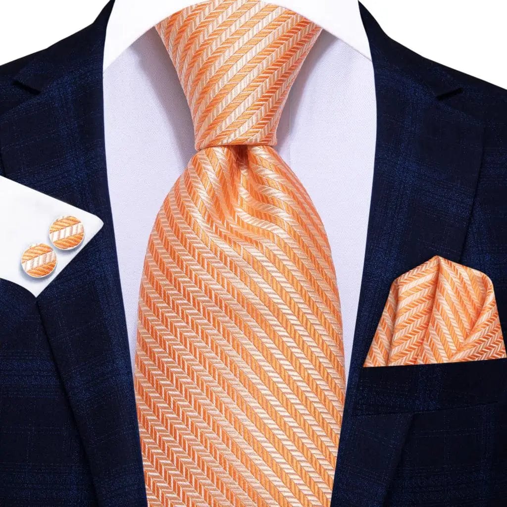Elegant orange silk necktie set with matching pocket square and cufflinks, ideal for formal occasions and weddings.