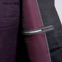 A close-up of a purple suit jacket featuring a textured fabric and a decorative pocket detail.