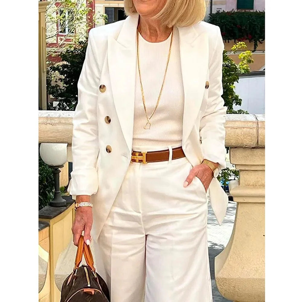 White double-breasted women's suit by SHOWLU FASHION with peak lapel jacket and matching pants, perfect for formal occasions.