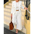 Women's white double-breasted suit by SHOWLU FASHION, featuring a peak lapel jacket and matching pants for elegant summer wear.
