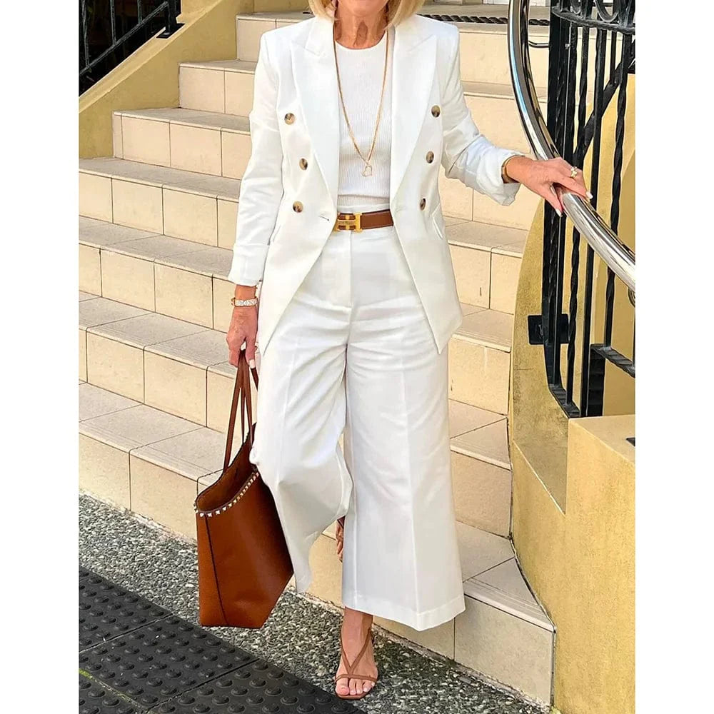 Women's white double-breasted suit by SHOWLU FASHION, featuring a peak lapel jacket and matching pants for elegant summer wear.