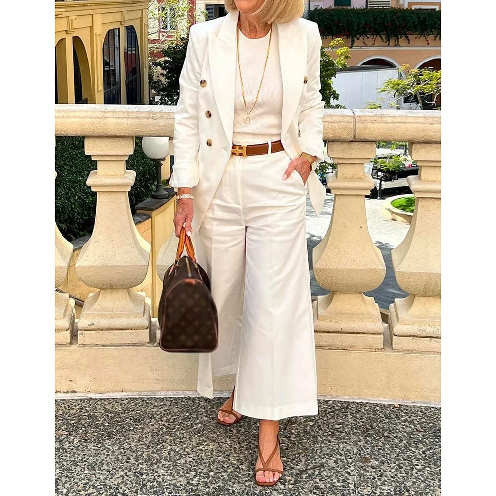 White women's double-breasted suit with peak lapel jacket and matching pants, stylish and elegant for summer and formal occasions.