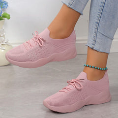 A pair of light pink breathable mesh sneakers with lace-up closures and platform soles.