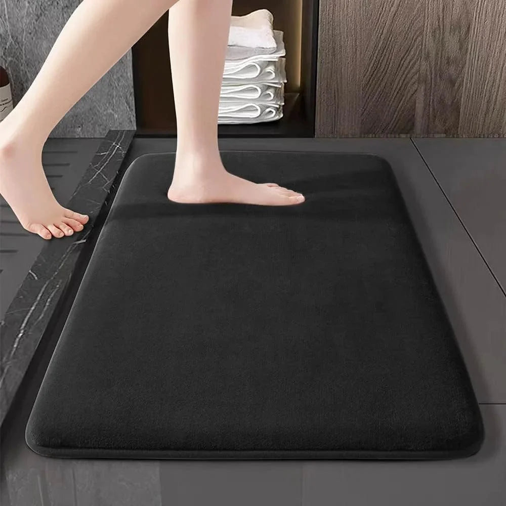 Showlu Fashion super absorbent coral velvet anti-slip bath mat on bathroom floor with textured surface and non-slip backing.
