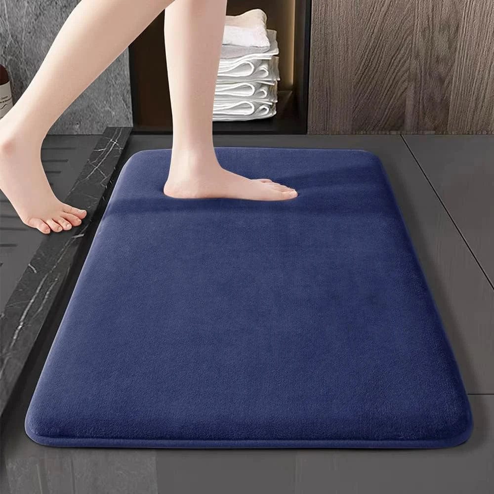 Showlu Fashion super absorbent coral velvet anti-slip bath mat on bathroom floor, featuring plush texture and non-slip backing.