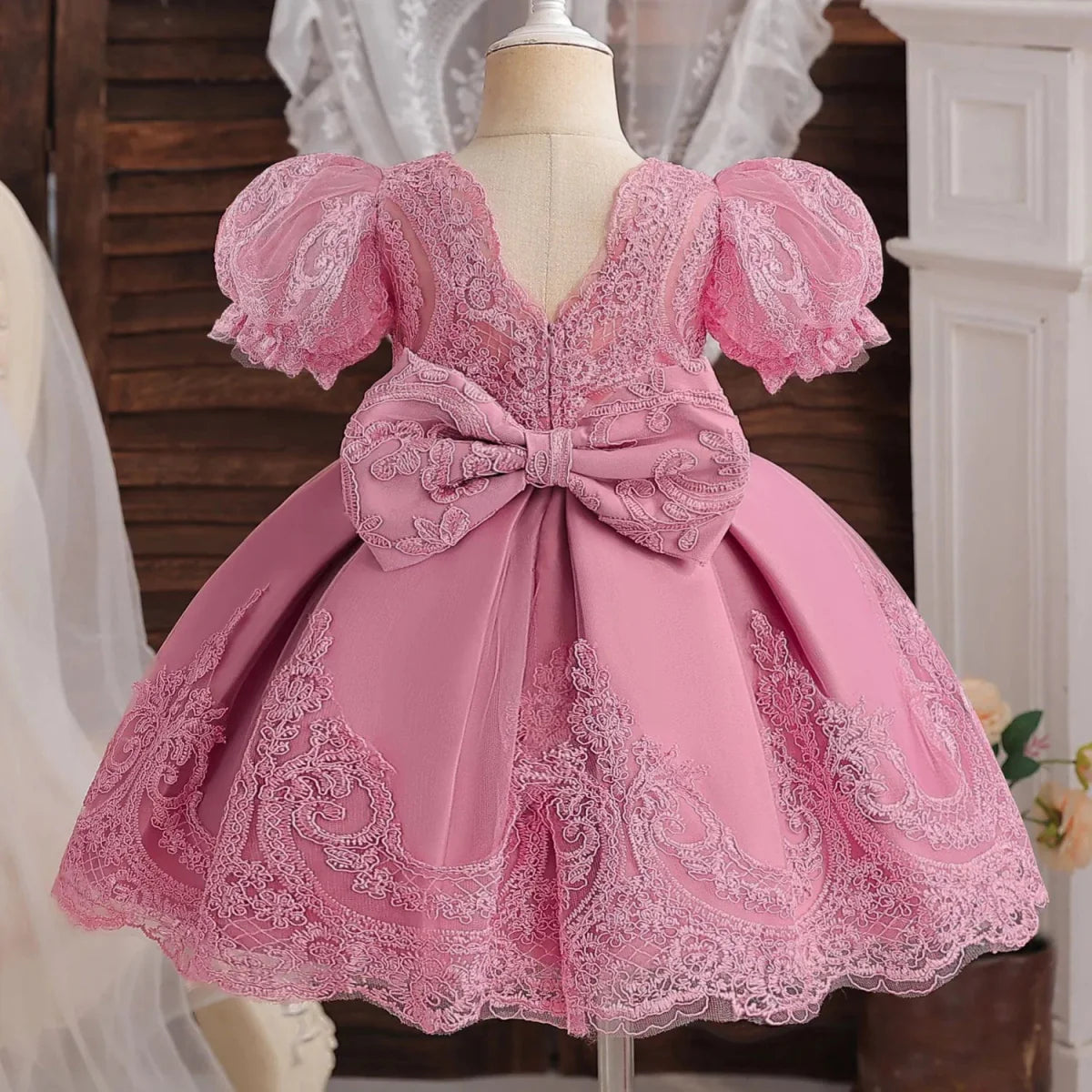 Toddler girl in a Showlu Fashion lace embroidery beading dress for 1st birthday or baptism, with floral details and satin sash.
