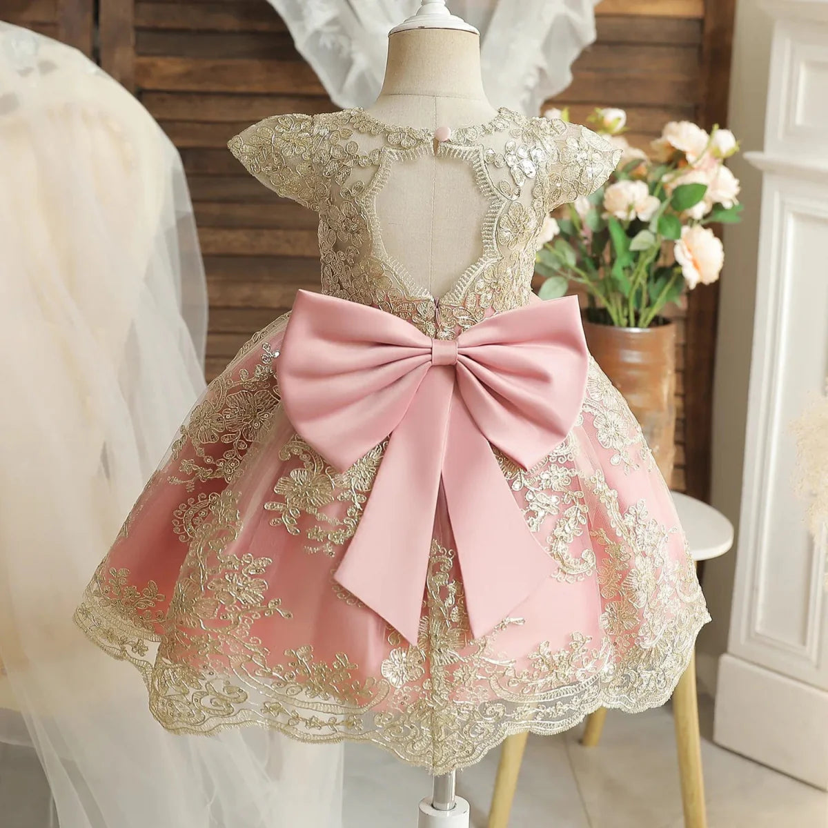 Toddler girl in a white lace embroidered beading dress for 1st birthday or baptism, designed for baby girls' special occasions.