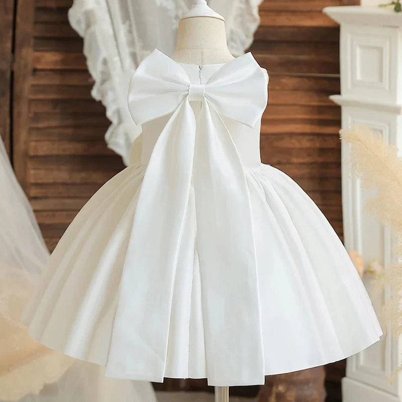 Toddler girl in a large bow baptism dress by SHOWLU FASHION STORE, suitable for princess parties, weddings, and special occasions.
