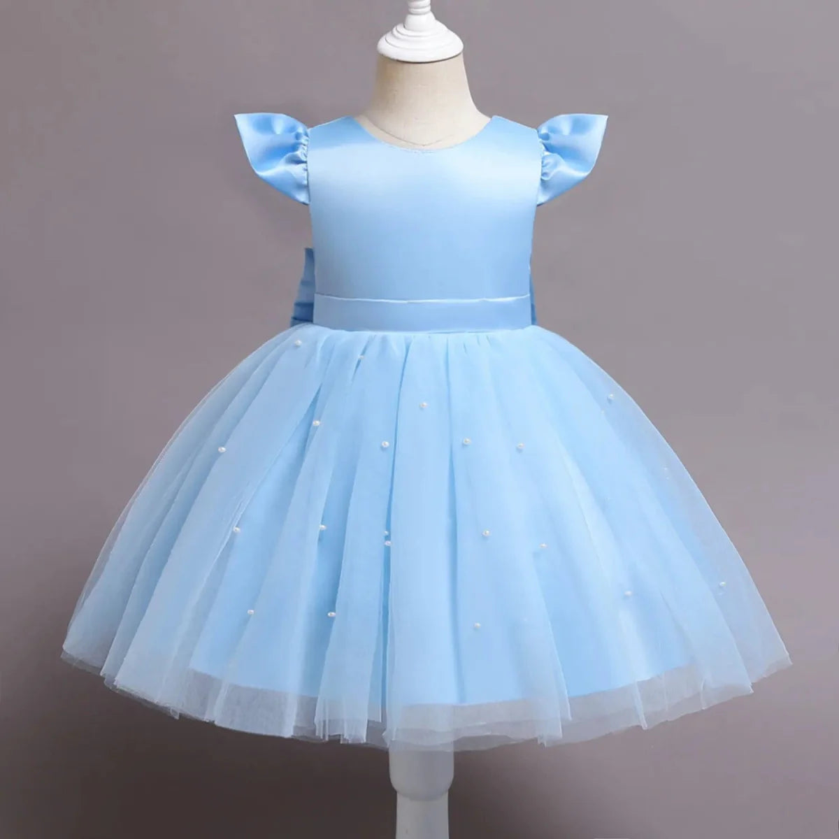 Toddler girl blue beaded tutu gown with V-back and bow, tulle fabric, perfect for birthday parties and special occasions.